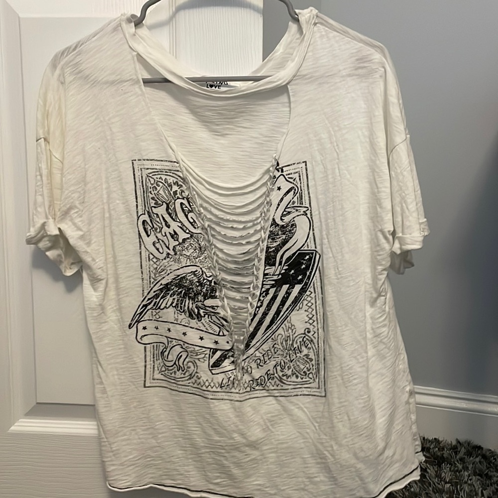 oversized, distressed white tee says “eagle” and “live to ride ride to live”